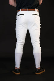 Back view of a male model wearing the white Free Ride Men's PRO Knee Patch Breeches on a black background