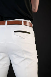 Close-up back view of a male model wearing the white Free Ride Men's PRO Knee Patch Breeches on a black background
