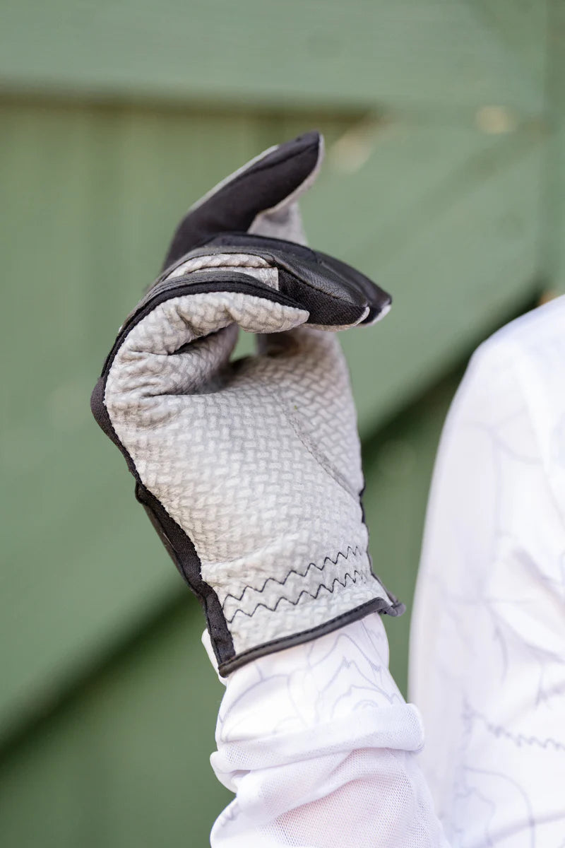 Close-up of a hand wearing a Correct Connect Oil-Tac Copper Tech Leather Premium Riding Glove in black