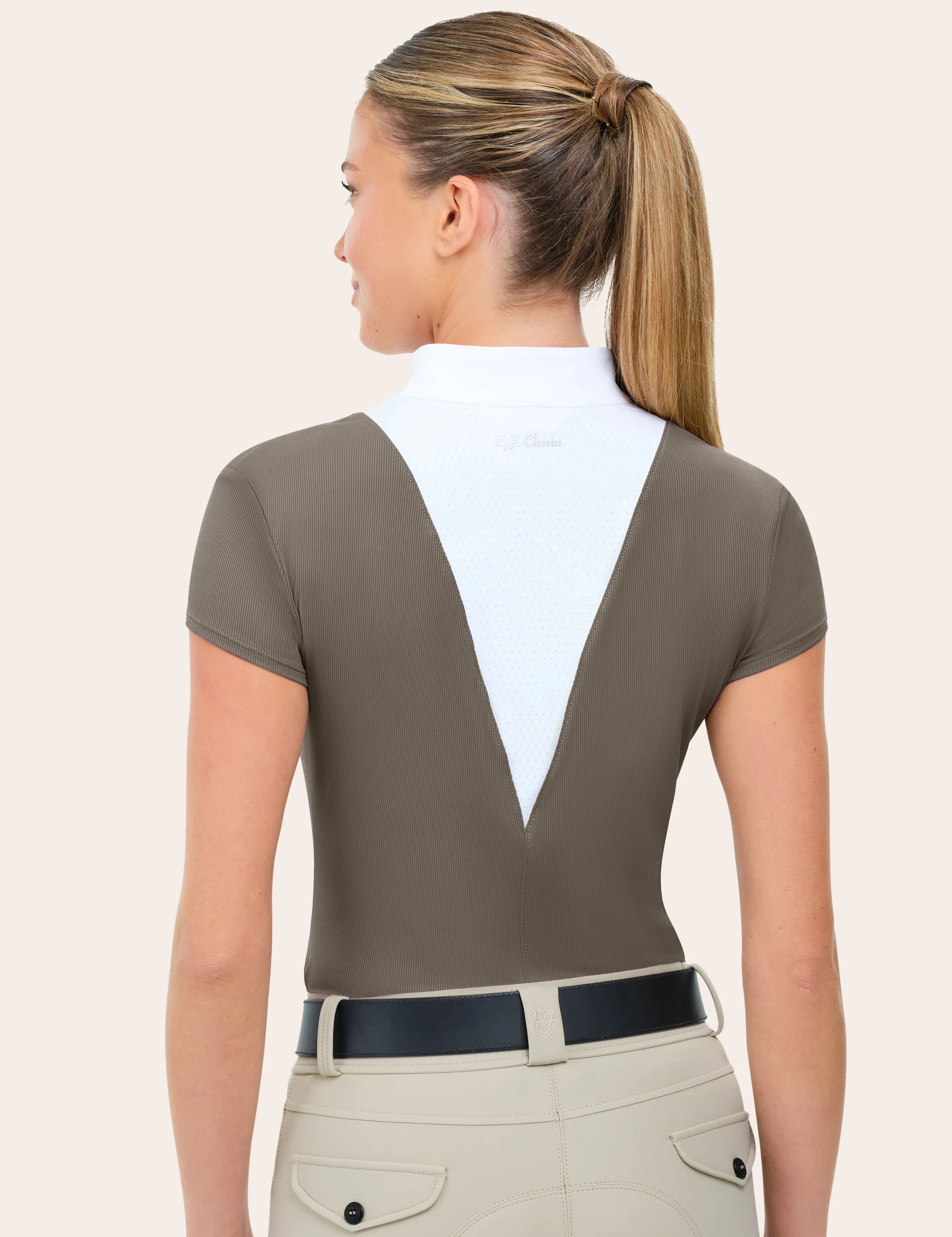 Woman wearing RJ Classics Celeste Show Shirt in Taupe, back view with belt and breeches