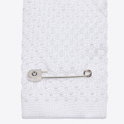 Close-up of Cavalleria Toscana white tricot knit tie showing textured knit pattern and silver tie pin on back