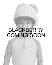 Coming Soon infographic front view of a young female model wearing the Blackberry LeMieux Mini Double Pom Hat Silk on a plain background