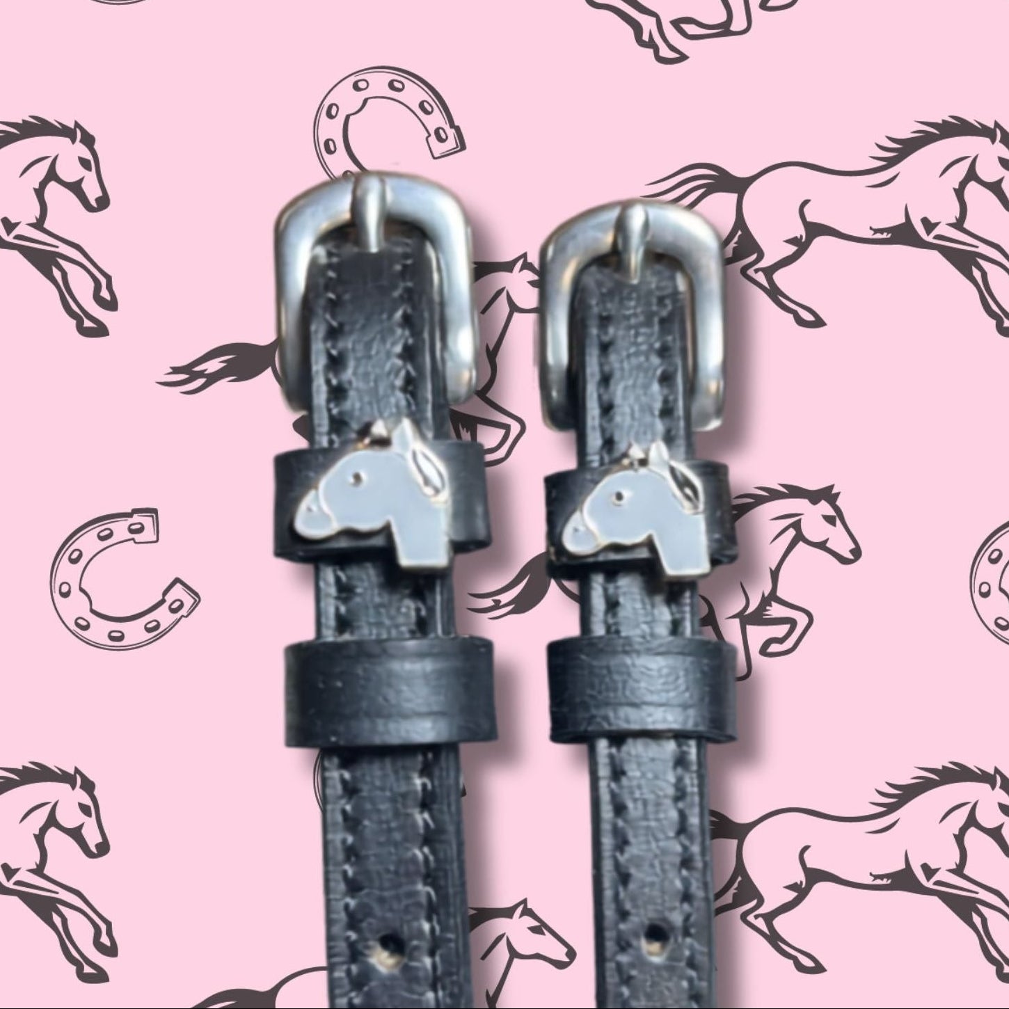 Close-up view of the Gray Horse Mane Jane Spur Straps on a pink equestrian background