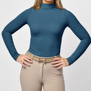 Front view of a female model wearing the Gulfstream TKEQ Chloe High Collar Technical Top on a plain background