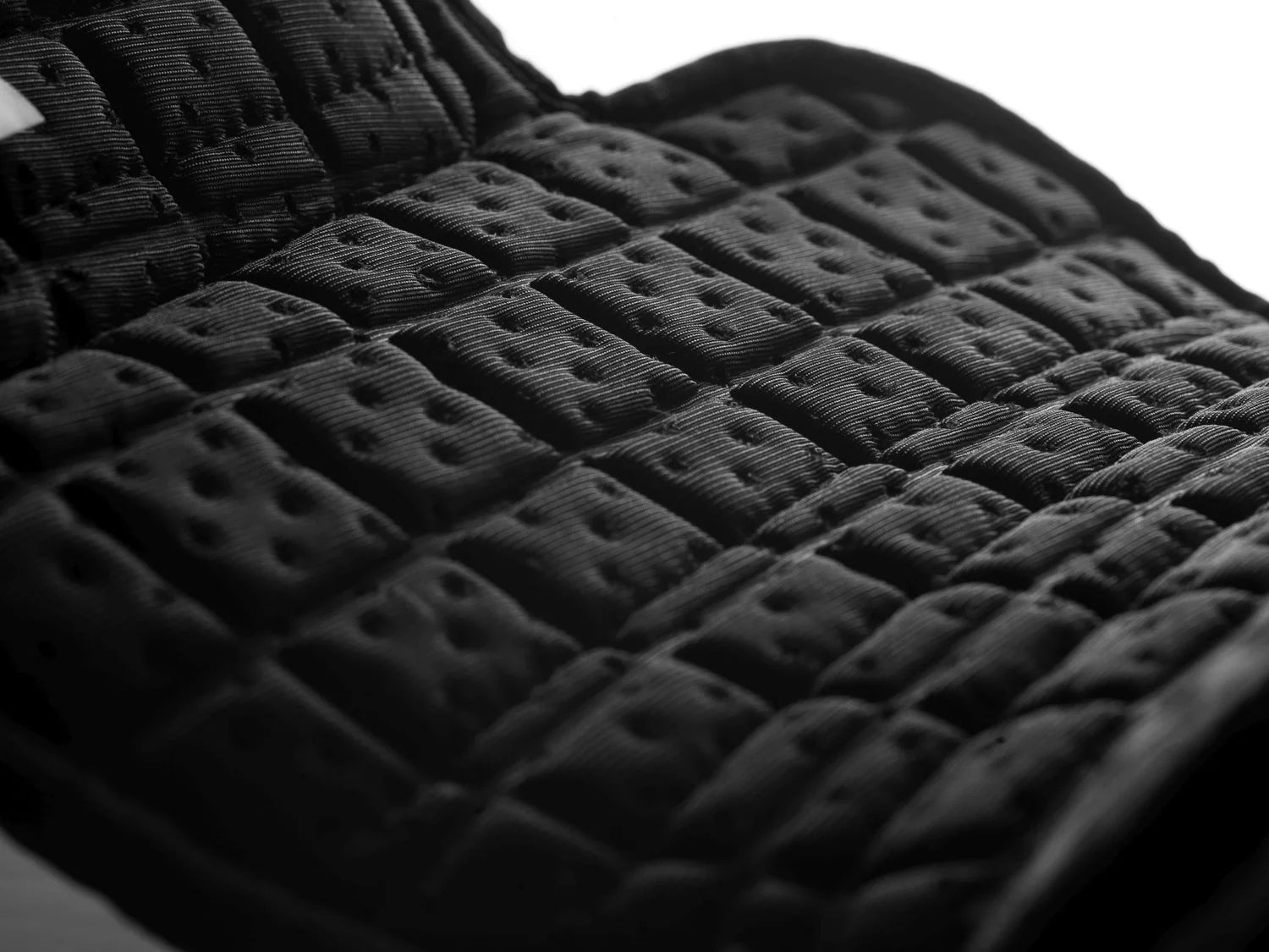 Close-up interior view of the black Equilibrium Tri-Zone Impact Cross Country Front Boot on a white background