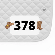 Side view of a white pad with numbers 378 and a pair of Cowgirl Dubois Cheval Number Pin Charms on a white background