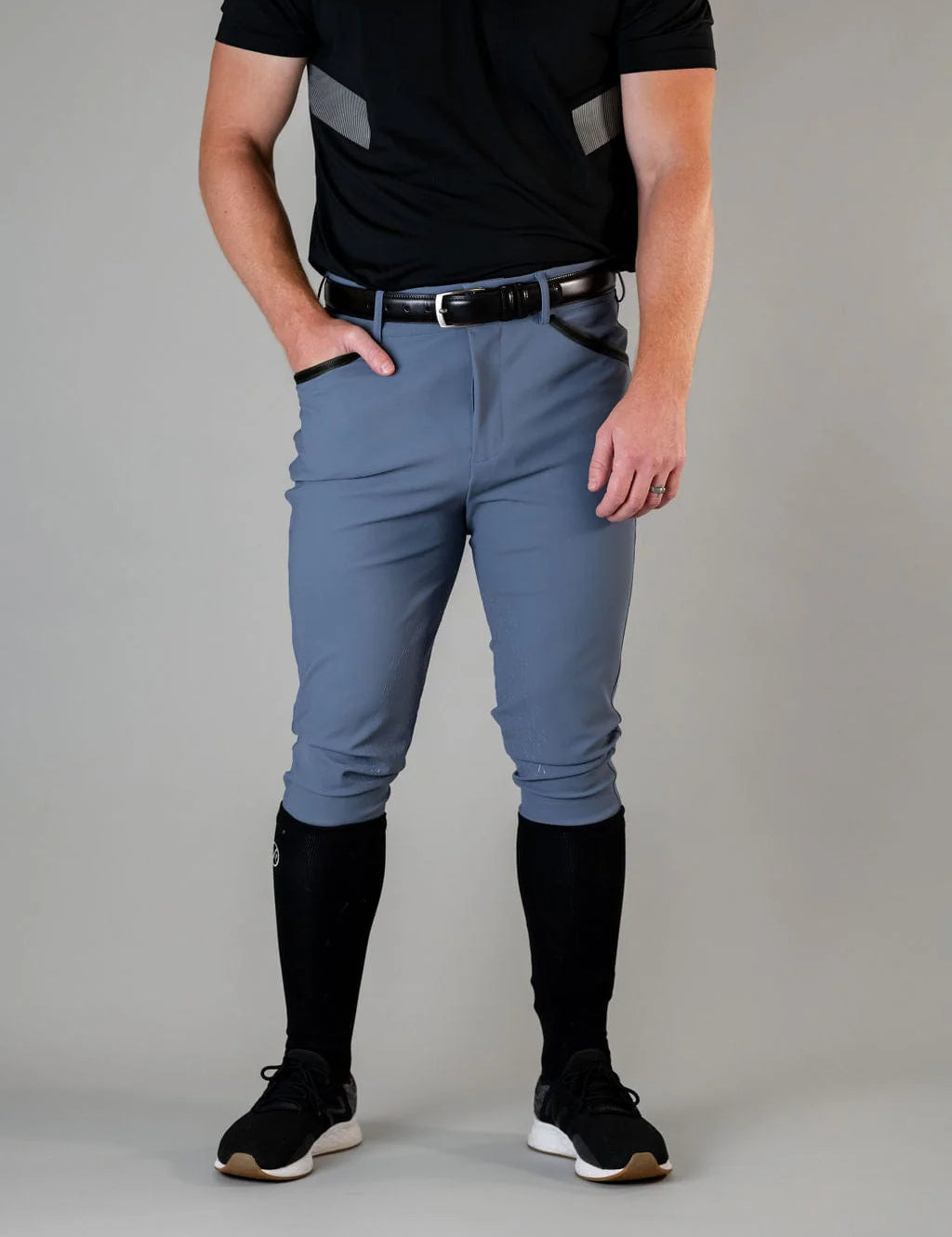 Front view of a male model wearing the blue Free Ride Men's PRO Knee Patch Breeches on a plain background