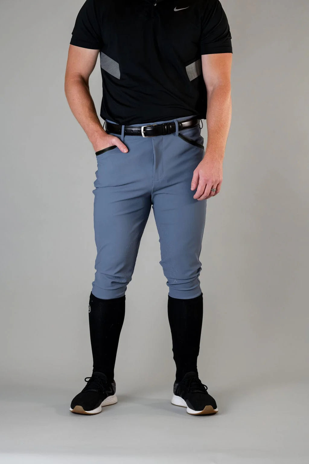Front view of a male model wearing the blue Free Ride Men's PRO Knee Patch Breeches on a plain background