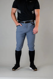 Front view of a male model wearing the blue Free Ride Men's PRO Knee Patch Breeches on a plain background