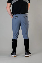 Back view of a male model wearing the blue Free Ride Men's PRO Knee Patch Breeches on a plain background