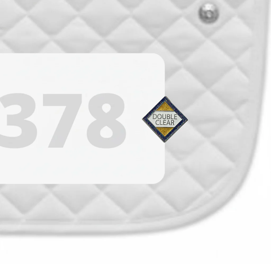 Side view of a white pad with numbers 378 and a Double Clear Dubois Cheval Number Pin Charm on a white background