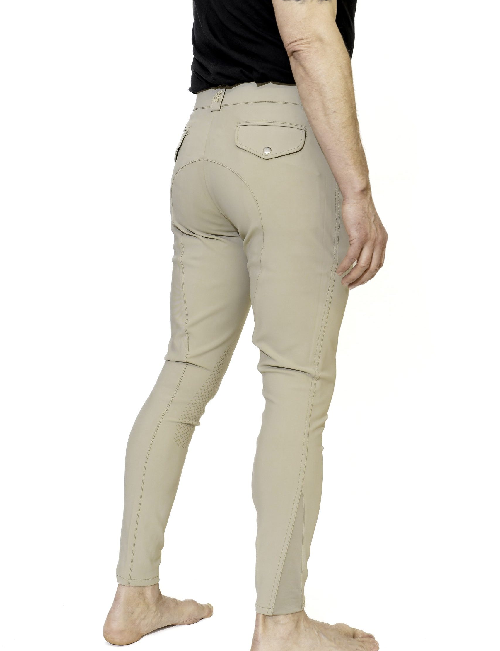 Angled back view of a male model wearing the beige KL Select Men's Evan Knee Patch Breeches on a white background