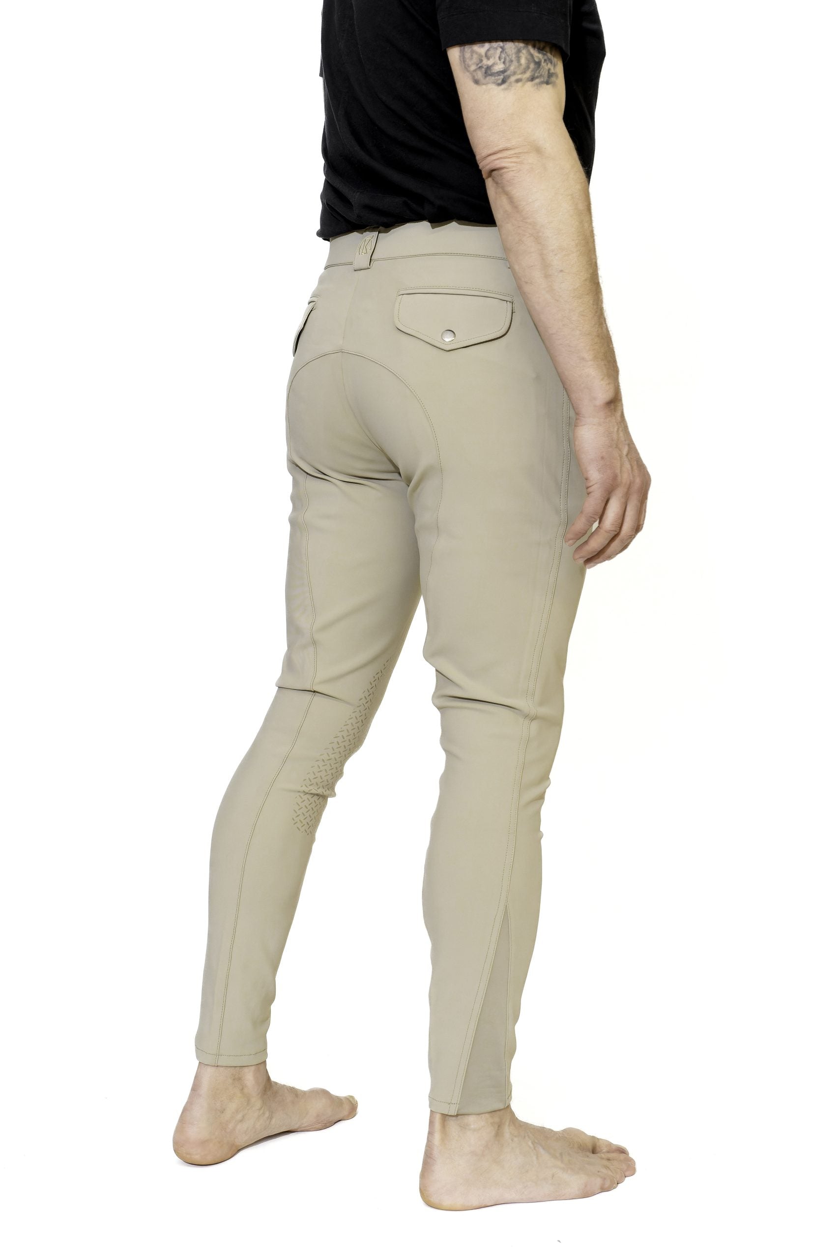 Angled back view of a male model wearing the beige KL Select Men's Evan Knee Patch Breeches on a white background