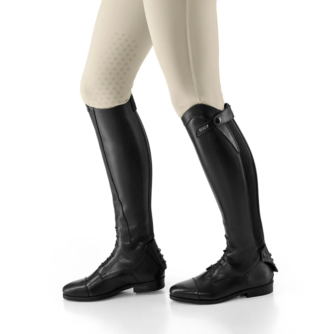 Side view of a model wearing a black pair of Ego 7 Orion Field Boot on a white background