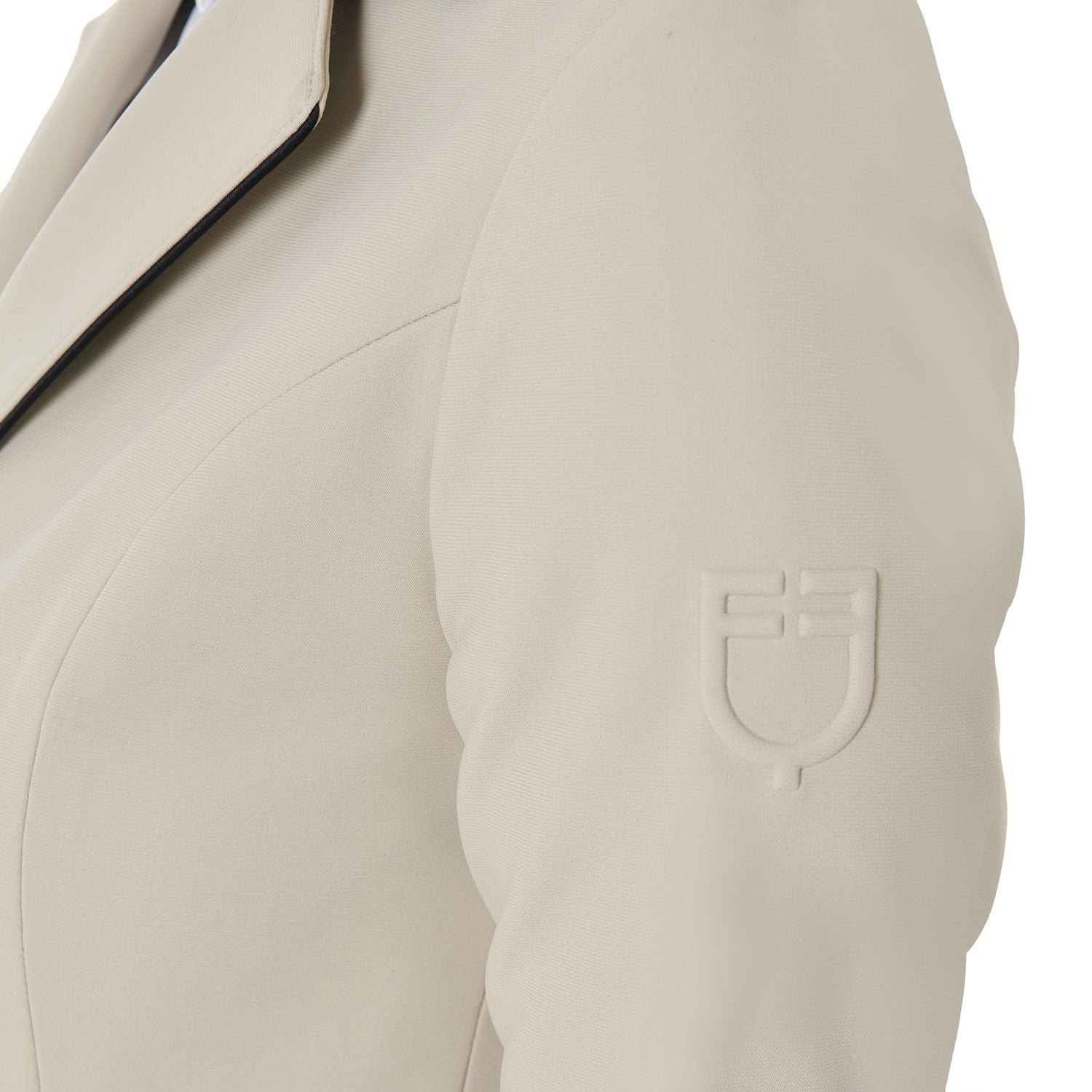 Close up view of the embossed shoulder logo on the Equestro Women's Three-Button Competition Jacket in tan on a white background