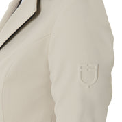 Close up view of the embossed shoulder logo on the Equestro Women's Three-Button Competition Jacket in tan on a white background