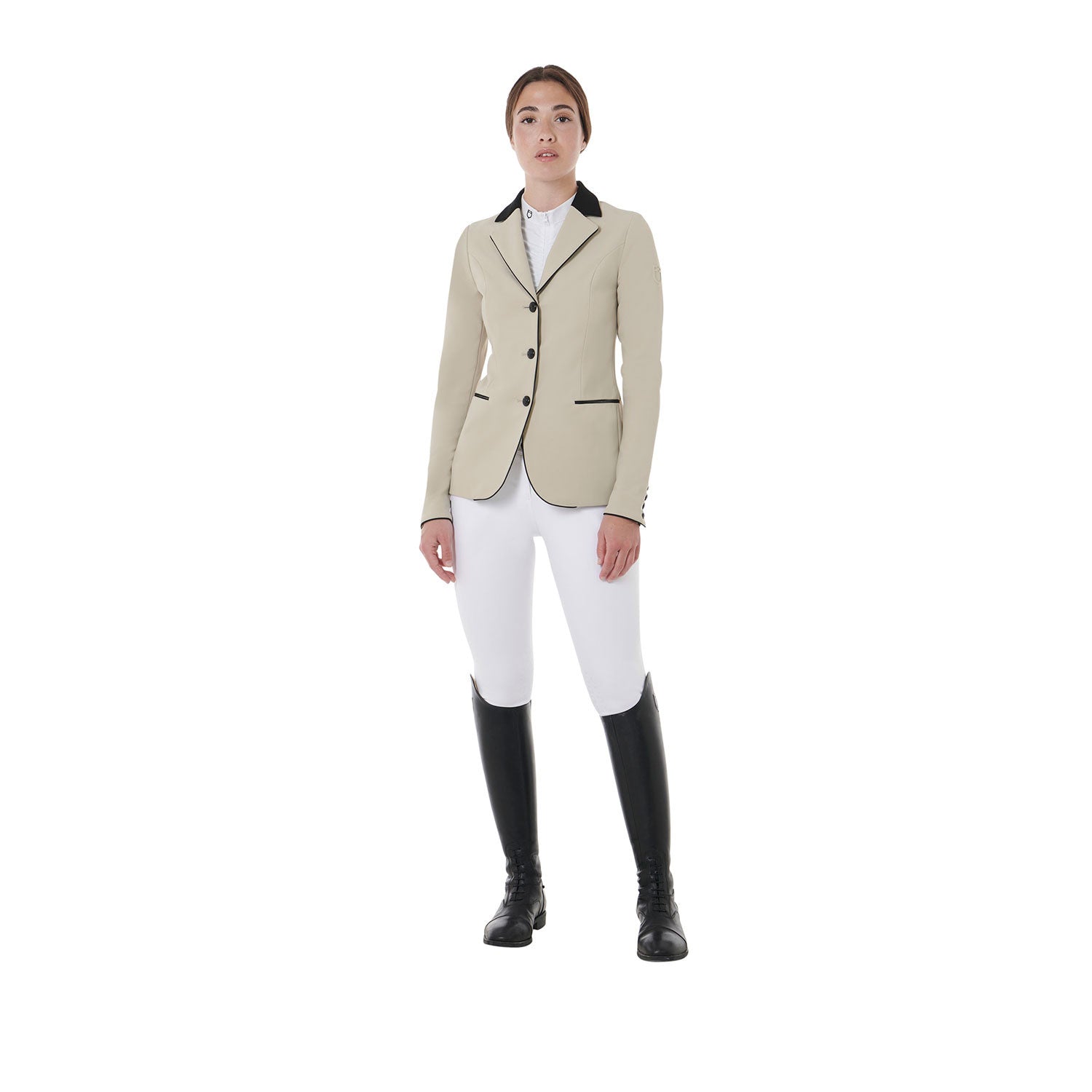 Full body view of model wearing the Equestro Women's Three-Button Competition Jacket in tan, white breeches, and black tall boots on a white background