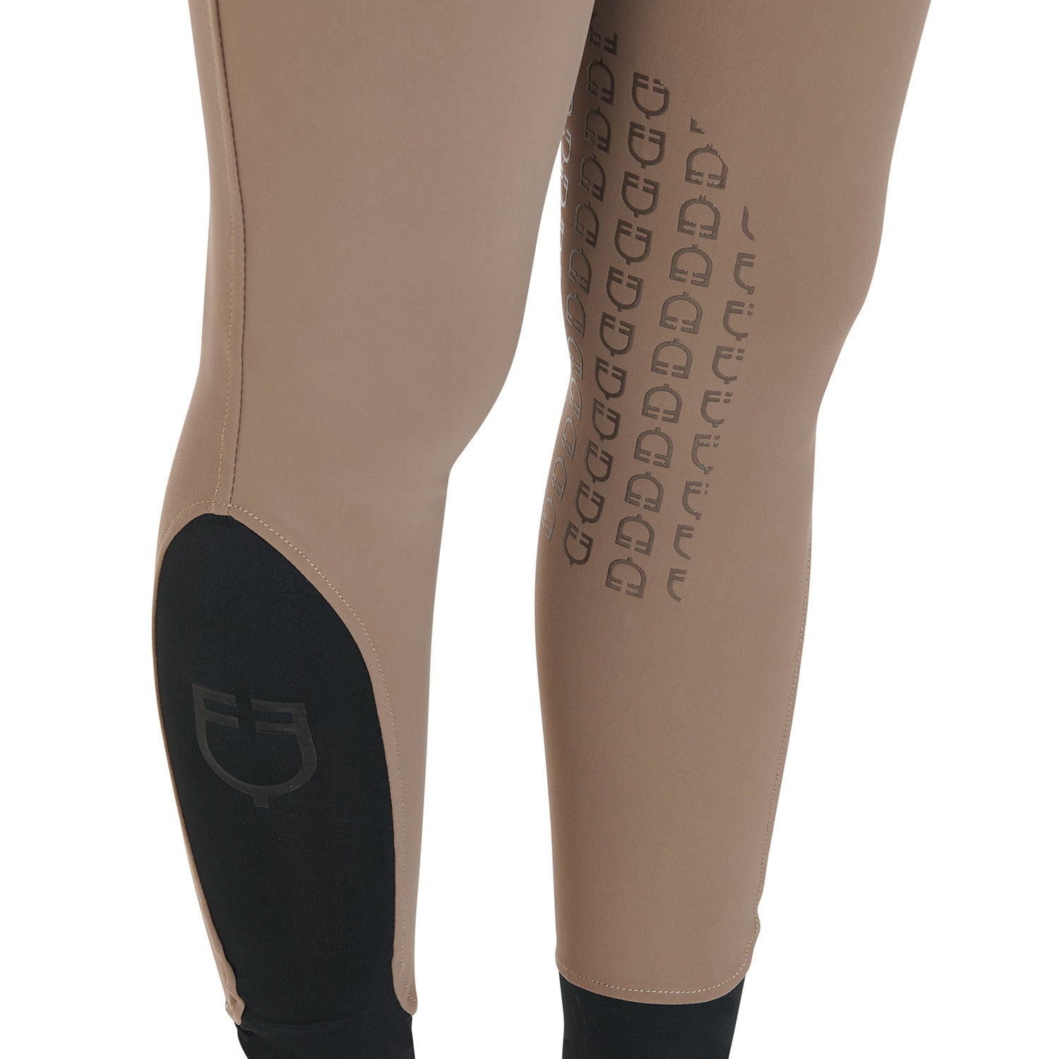 Close up view of the knee grip and lower leg logo on the Equestro Women's Slim Fit Grip Breeches With Logo in tan on white background