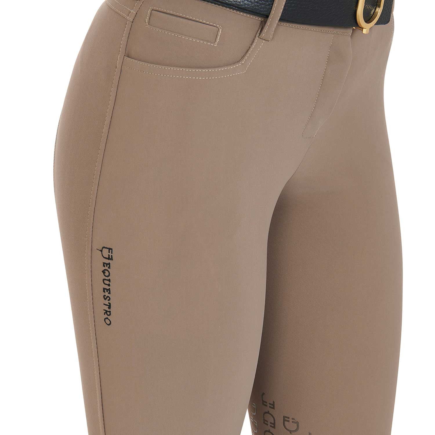 Close up view of the front pocket of the Equestro Women's Slim Fit Grip Breeches With Logo in tan on white background