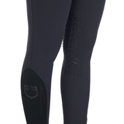 Close up view of the knee grip and lower leg logo on the Equestro Women's Slim Fit Grip Breeches With Logo in navy on white background