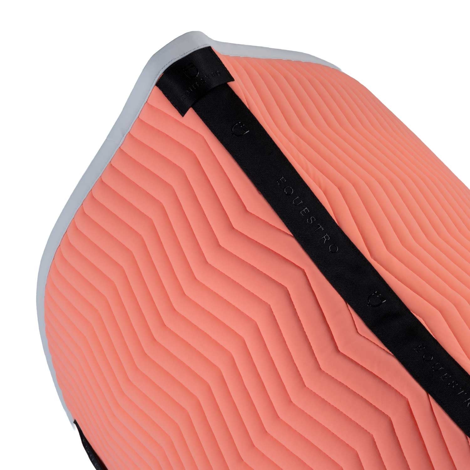 Close up top view of the Equestro Wave Quilting Jump Saddle Pad In Technical Fabric in a coral color on a white background
