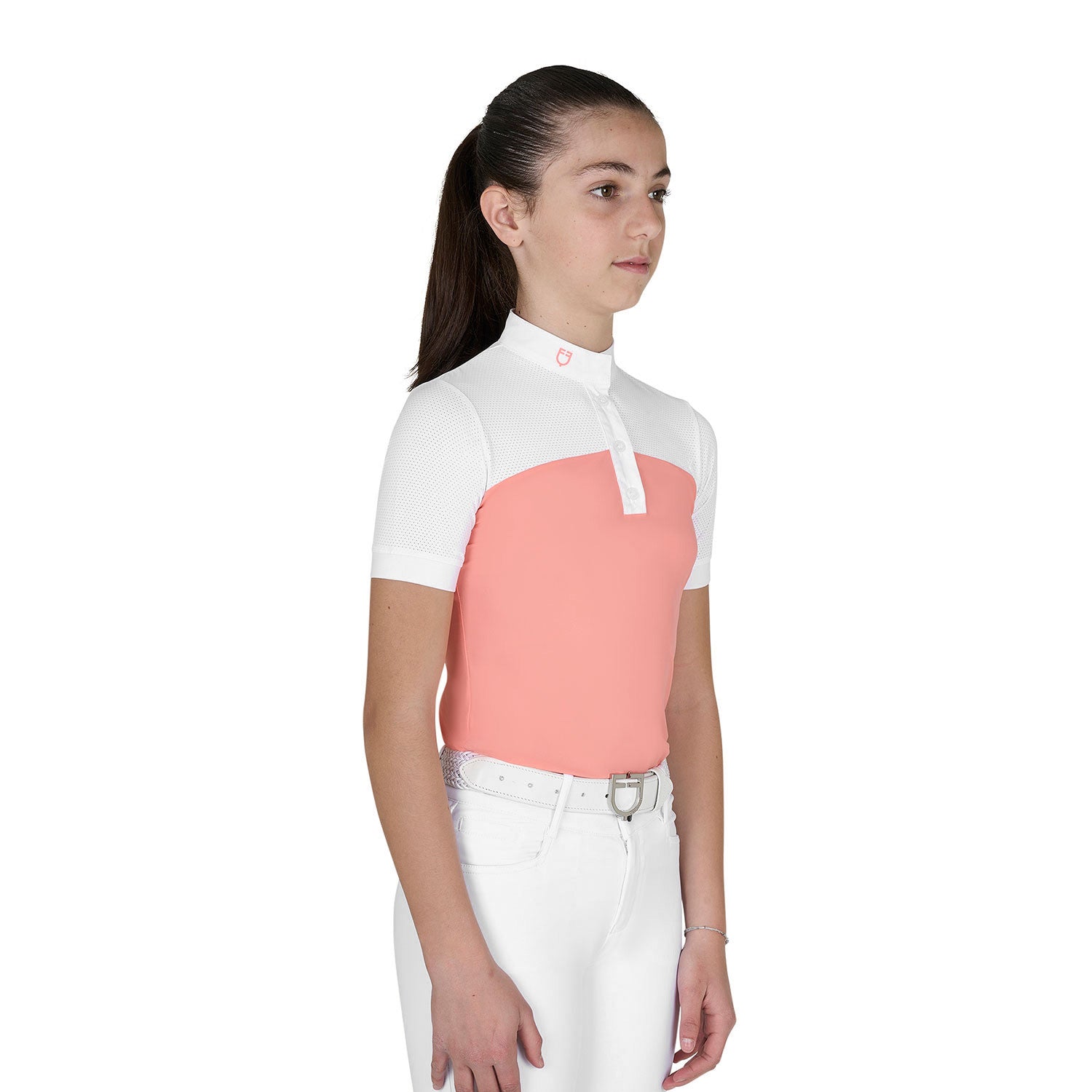 Angled front view of young model wearing the Girls' Slim Fit Competition Polo Shirt With Perforated Fabric in white and pink on a white background