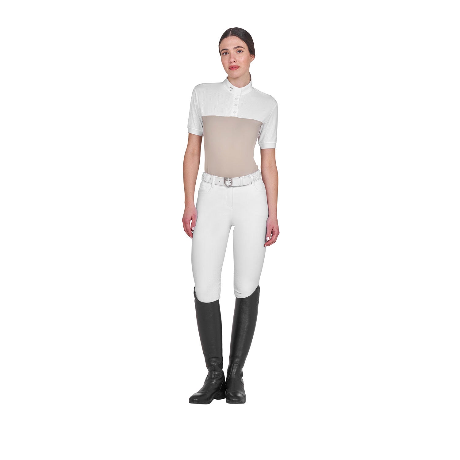 Full body view of model wearing the Equestro Women's Slim Fit Polo Shirt In Technical Fabric And Mesh in tan, white breeches, and black tall boots and white on a white background