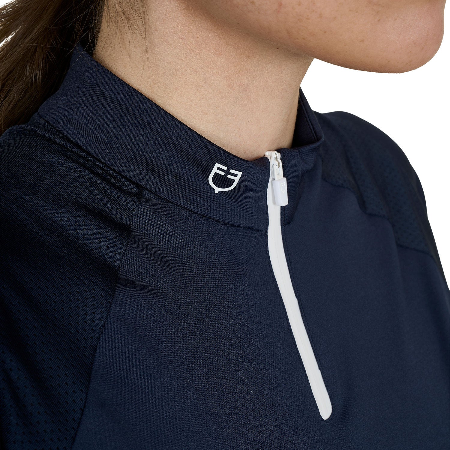 Close up front view of the collar, logo and quarter zip of the Equestro Women's Slim Fit Technical Training Polo Shirt in navy