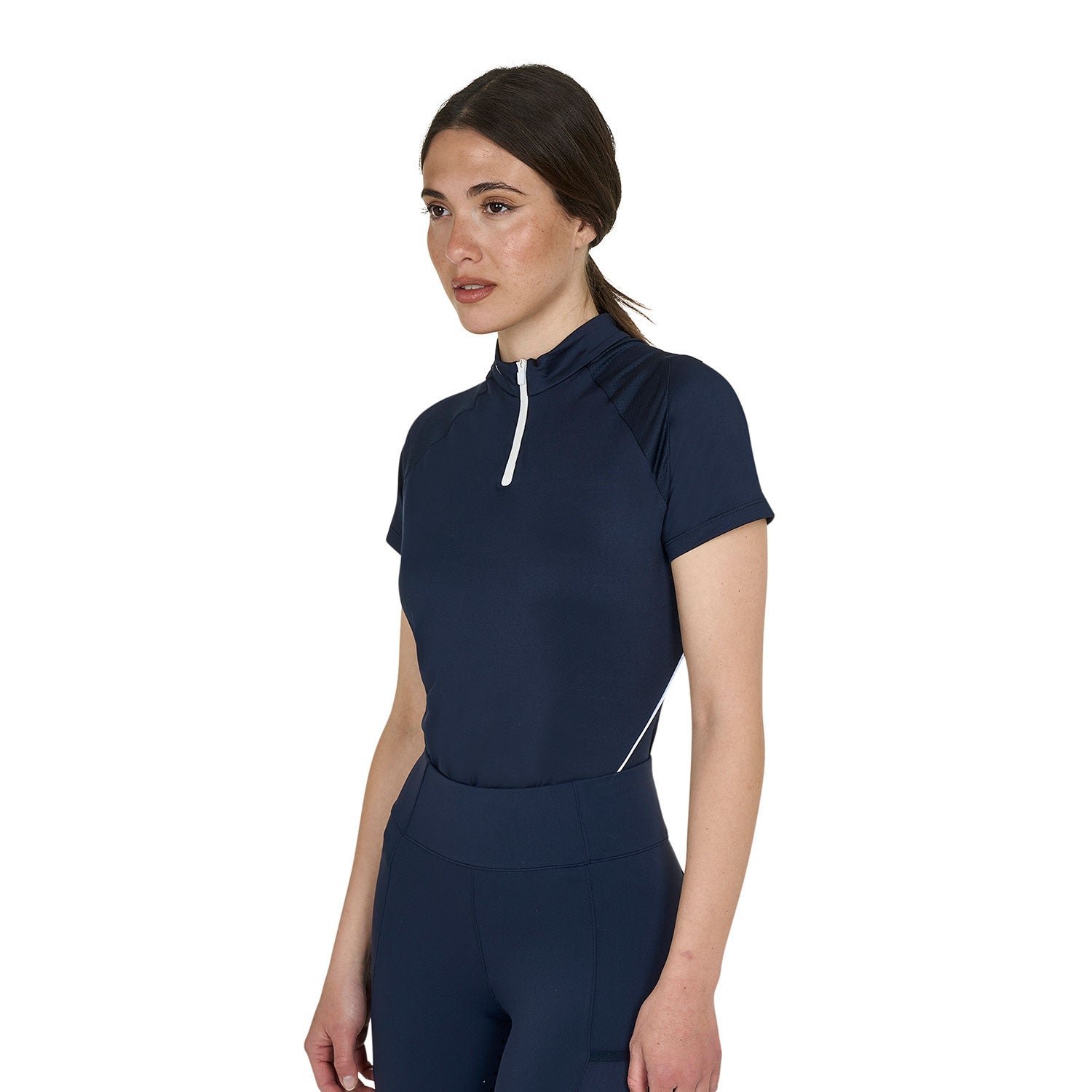 Angled front view  of a model wearing the Equestro Women's Slim Fit Technical Training Polo Shirt in navy with navy tights