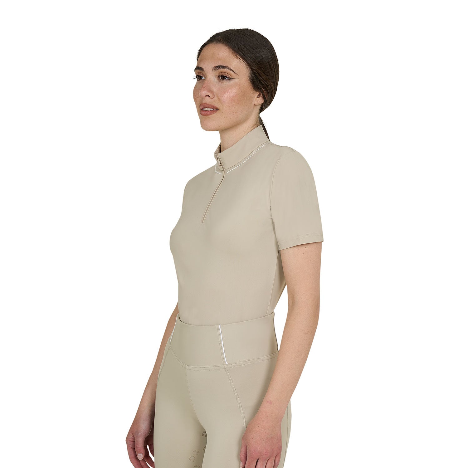 Angled front view of model wearing the Equestro Women's Slim Fit Training Polo Shirt With Zip And Collar Beads in tan on white background