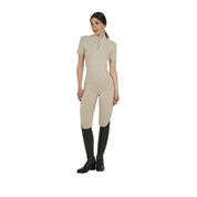 Full body front view of model wearing the Equestro Women's Slim Fit Training Polo Shirt With Zip And Collar Beads in tan, tan tights, and black tall boots on white background