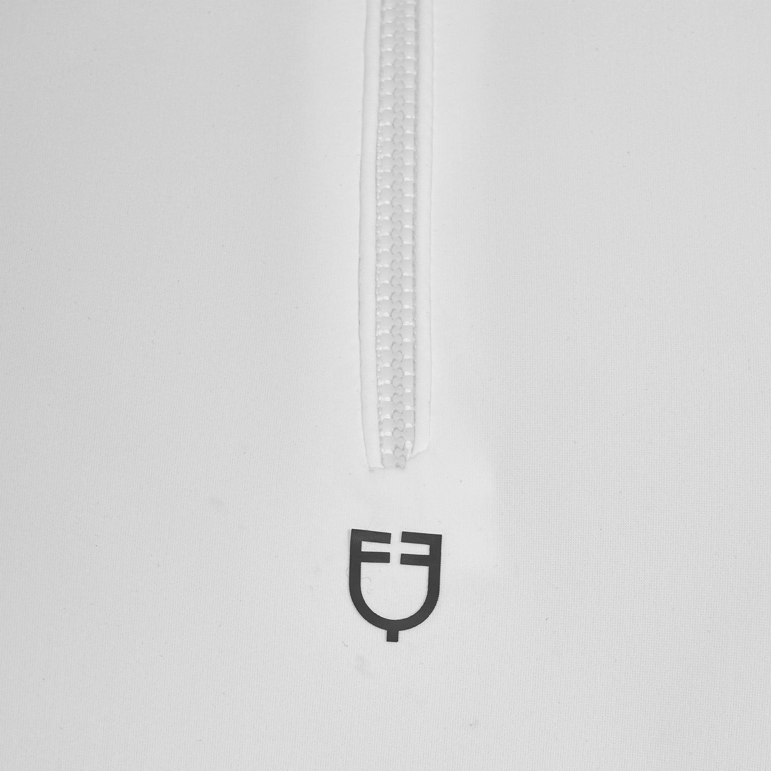 Close up view of the zipper and black Equestro logo on the Equestro Women's Slim Fit Training Polo Shirt With Zip And Collar Rhinestones in white