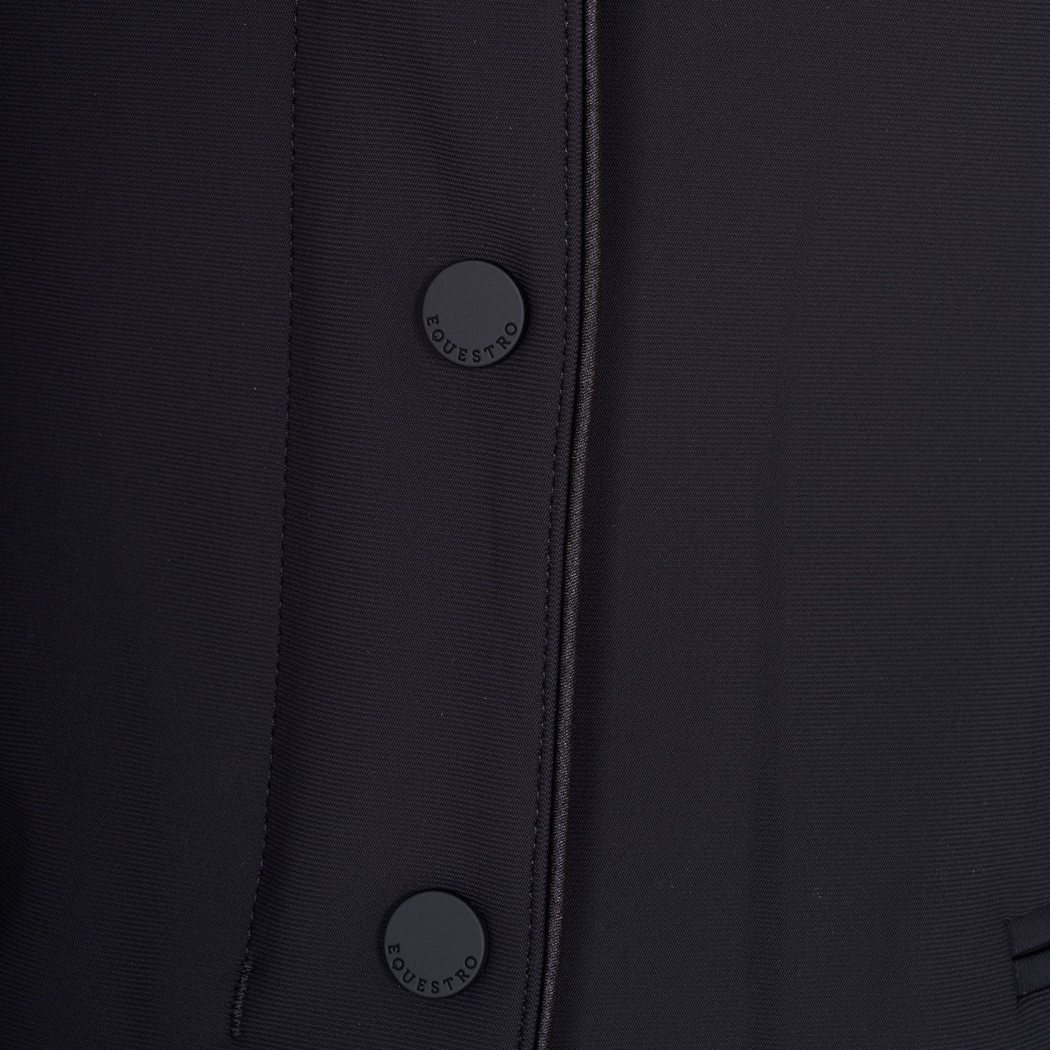 Close up view of the buttons on the Equestro Women's Competition Jacket With Zip And Buttons in black