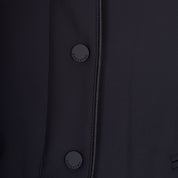 Close up view of the buttons on the Equestro Women's Competition Jacket With Zip And Buttons in black