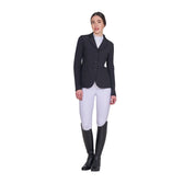 Full body front view of model wearing the Equestro Women's Competition Jacket With Zip And Buttons in black, white breeches, and black tall boots on a white background