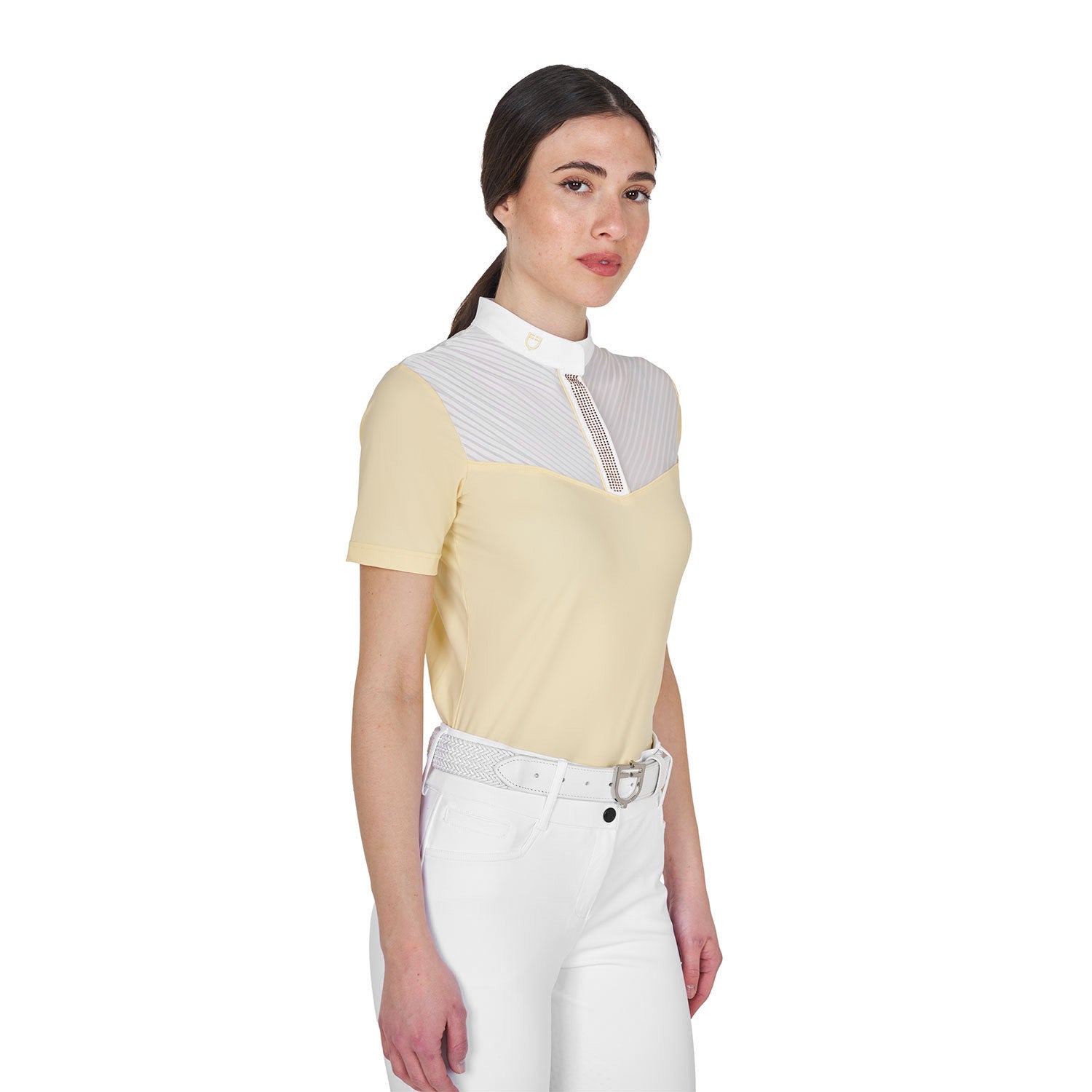 Angled front view of model wearing the Equestro Women's Slim Fit Competition Polo Shirt With Silk-Like Fabric Inserts in white and yellow on a white background