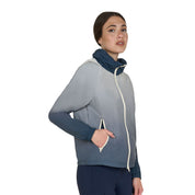 Angled front view of model wearing the Equestro Women's Water-Repellent Outerwear in ombre navy and white on a white background
