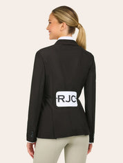 Back view of a woman wearing the brown RJ Classics Harmony Evo Mesh Show Coat with the letters RJC on a competition number holder on a plain background