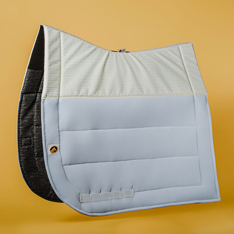 Side view of the white Ecogold Secure Dressage Pad on a yellow background