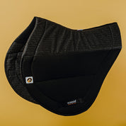 Side view of the black Ecogold Secure Cross Country Pad on a yellow background
