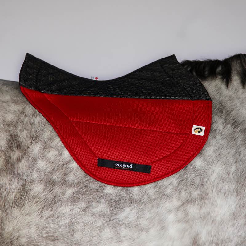 Side view of the red Ecogold Secure Cross Country Pad on a gray horse