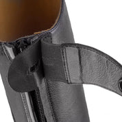 Close-up view of the top zip guard on a black Ego 7 Orion Field Boot on a white background