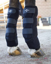 Close-up angled back view of a horse wearing the Professional's Choice Ice Boots while standing in an arena