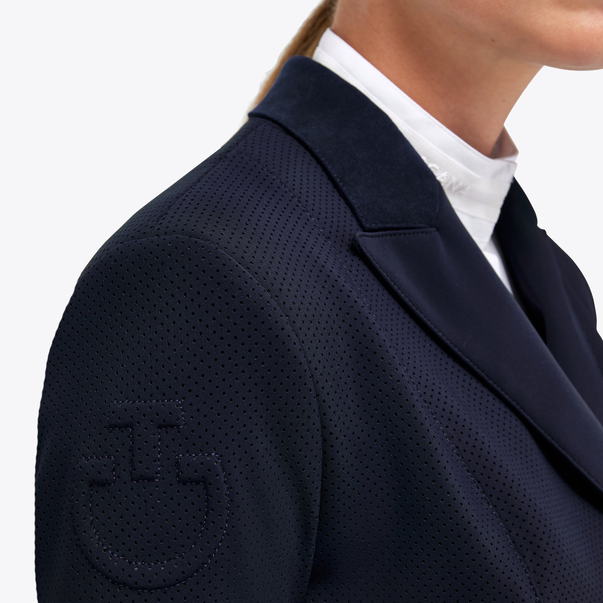 Close-up of Cavalleria Toscana navy competition frack showing textured fabric and embossed logo on shoulder