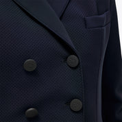 Close-up of Cavalleria Toscana navy competition frack showing double-breasted front with matte buttons