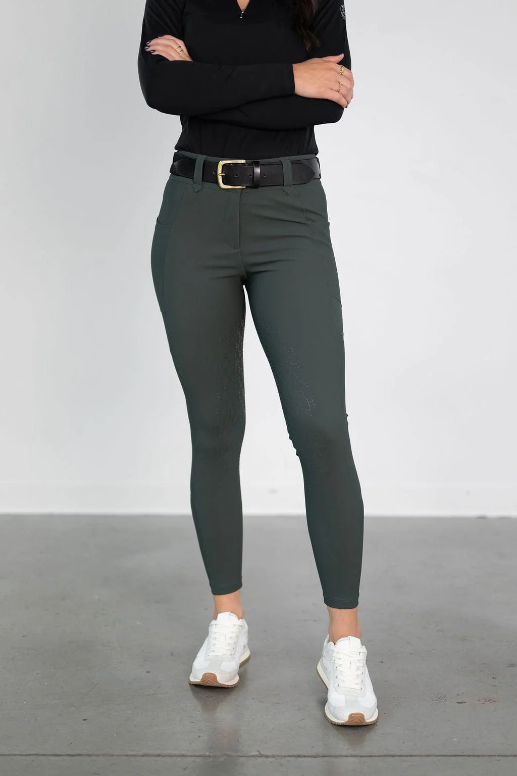 Front view of a model wearing the green Free Ride PRO Knee Patch Breeches in a studio setting