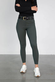 Front view of a model wearing the green Free Ride PRO Knee Patch Breeches in a studio setting