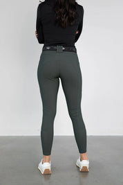 Back view of a model wearing the green Free Ride PRO Knee Patch Breeches in a studio setting