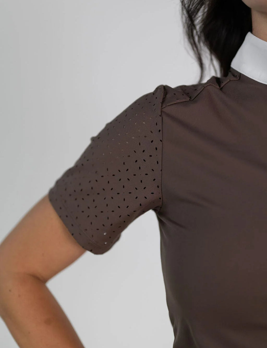 Close-up view of the laser cut perforations on the sleeve of the brown Free Ride Cassidy Short Sleeve Show Shirt