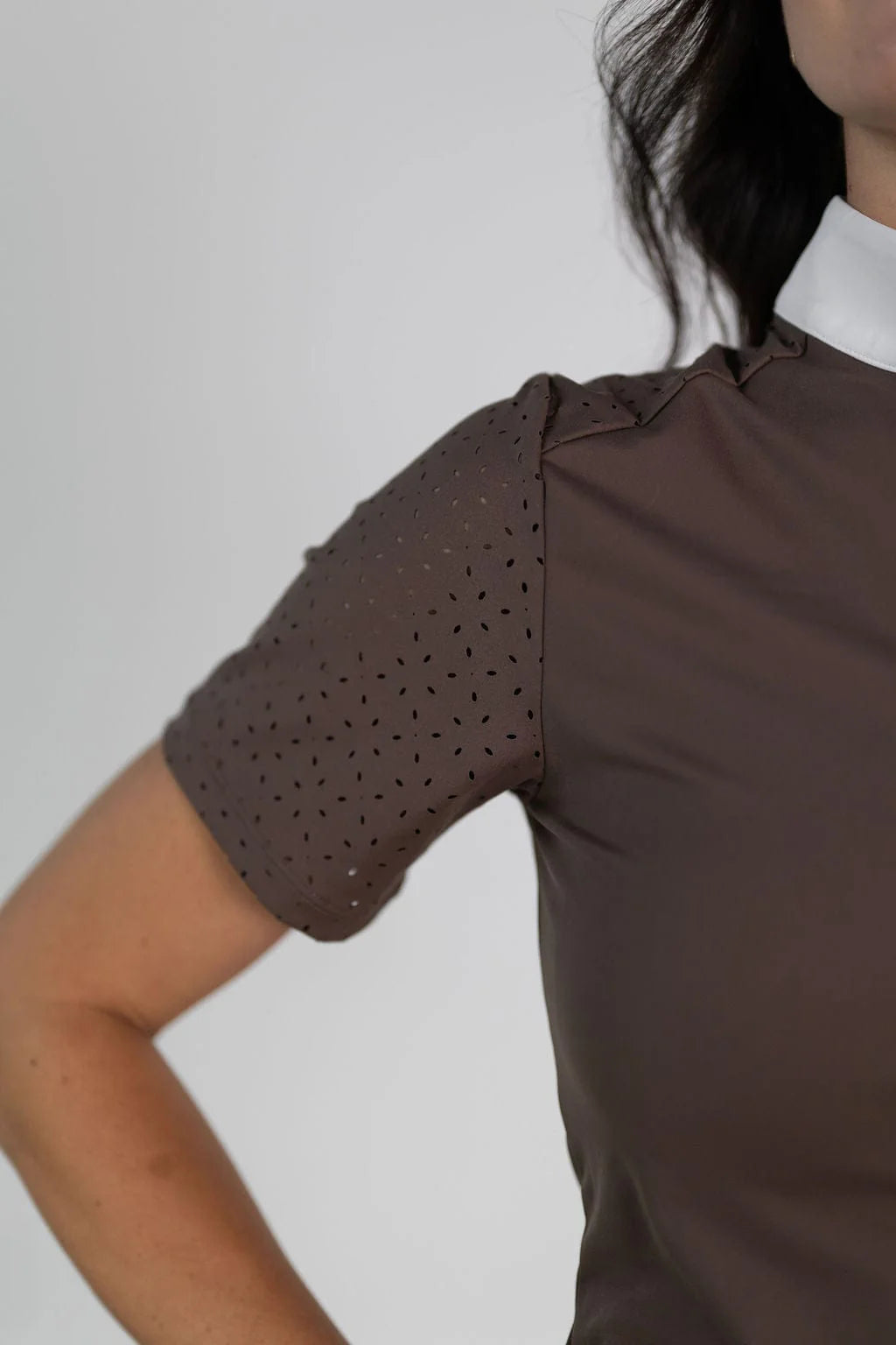 Close-up view of the laser cut perforations on the sleeve of the brown Free Ride Cassidy Short Sleeve Show Shirt